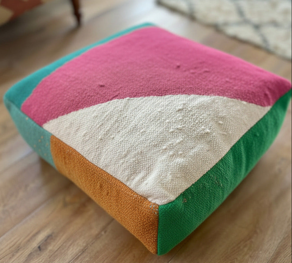 Colorful floor cushion with geometric pattern on a wooden floor
