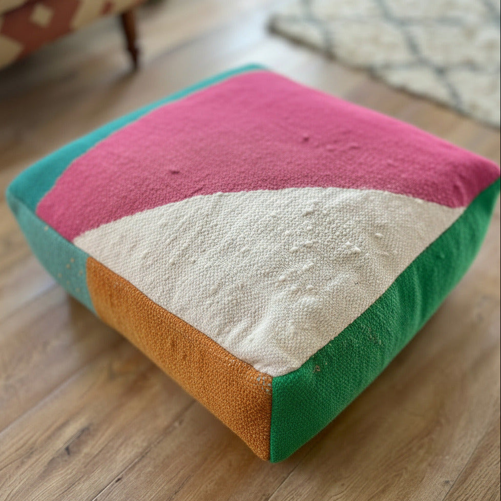 Colorful floor cushion with geometric pattern on a wooden floor