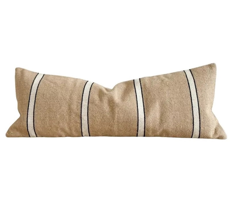 Beige pillow with white stripes on a white background