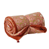 Rolled-up floral-patterned throw with pink colors on a white background