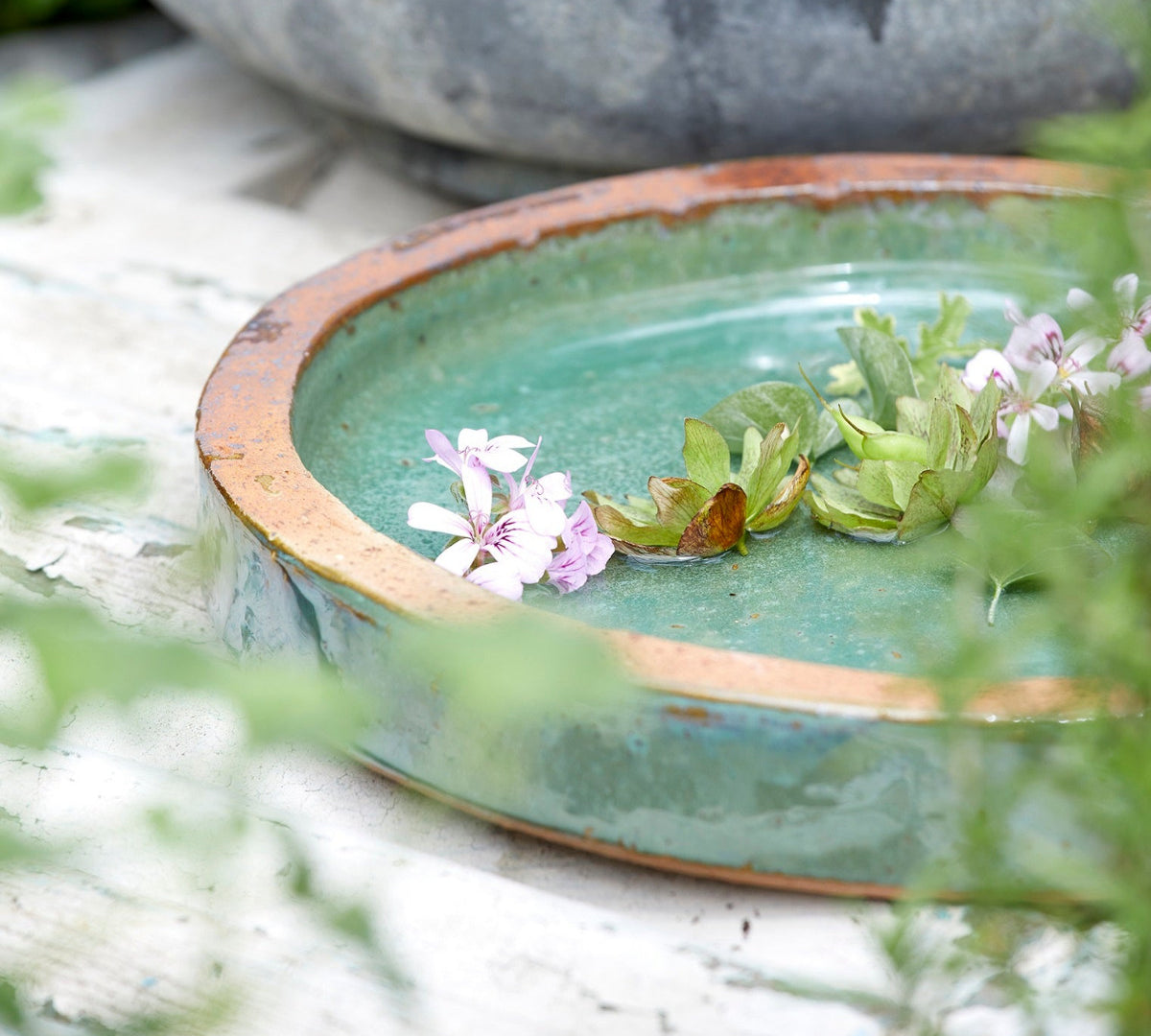 Close-up of jade green ceramic  birdbath