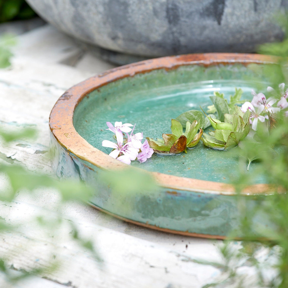 Close-up of jade green ceramic  birdbath