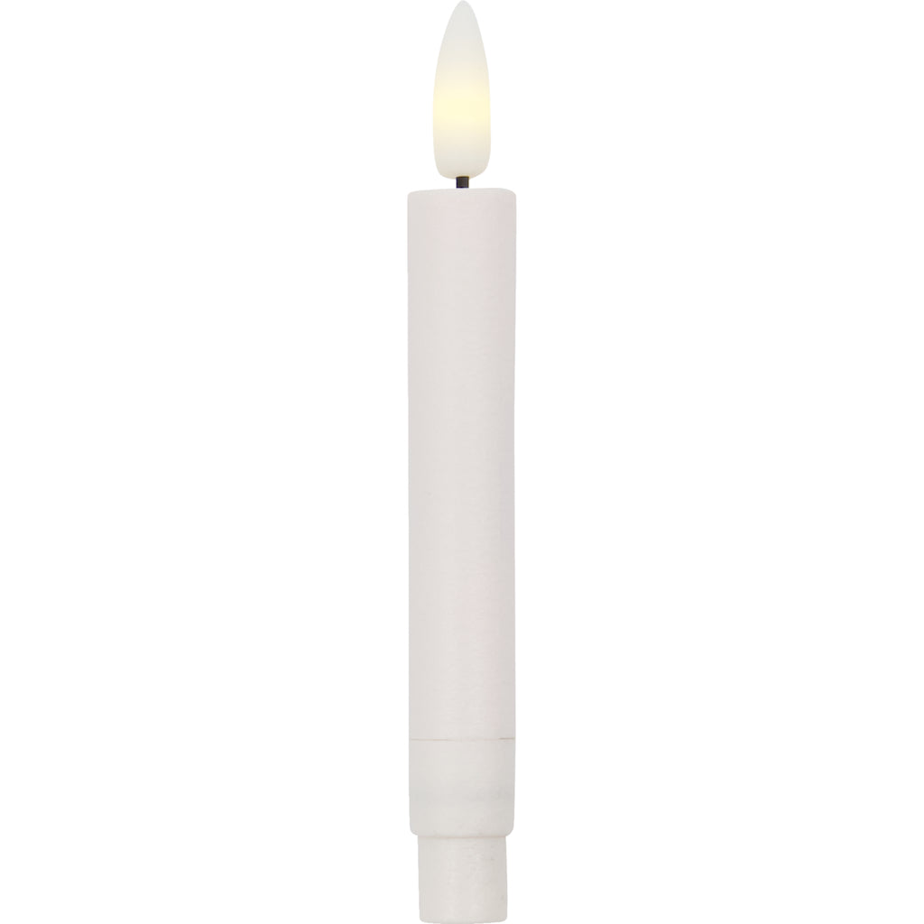 White candle with a lit LED wick on a white background