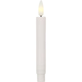 White candle with a lit LED wick on a white background