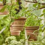 Terracotta pots with decorative iron hanging 