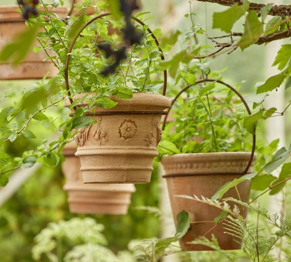 Terracotta pots with decorative iron hanging 