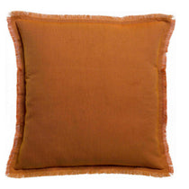 A square throw pillow in a warm rust-orange color with fringed edges, shown against a plain white background.