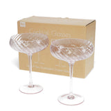 Two cocktail glasses in front of a cardboard box labeled 'Cocktail Glasses' on a white background.