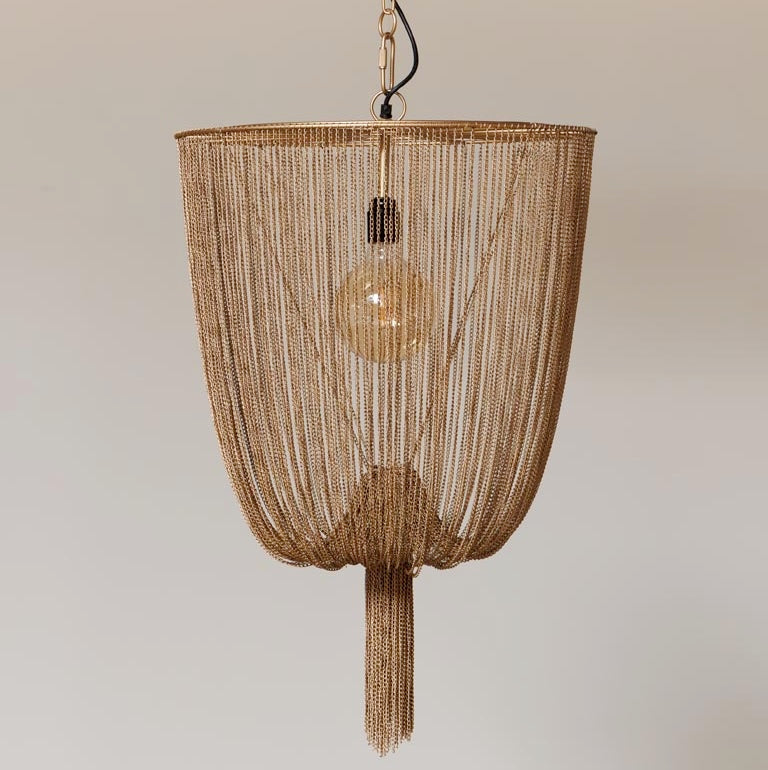 Gold beaded pendant light against a neutral background