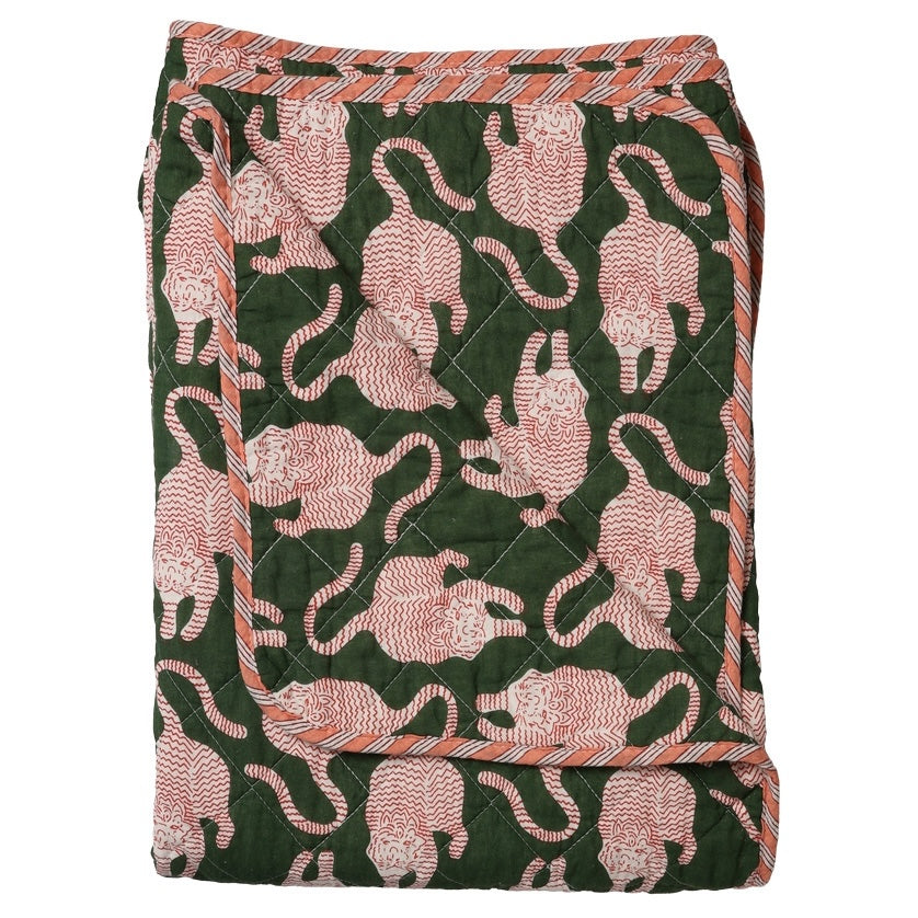 A folded quilted blanket featuring a dark green background with a repeating pattern of pink and white stylized cats, finished with a striped orange and white border.