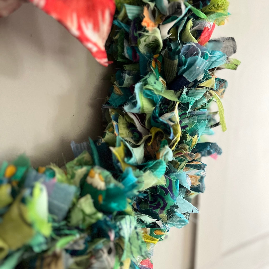 Colorful fabric wreath with a neutral background