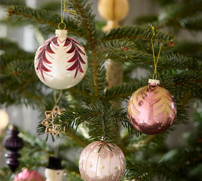 Decorative Christmas ornaments on a tree with a soft focus background