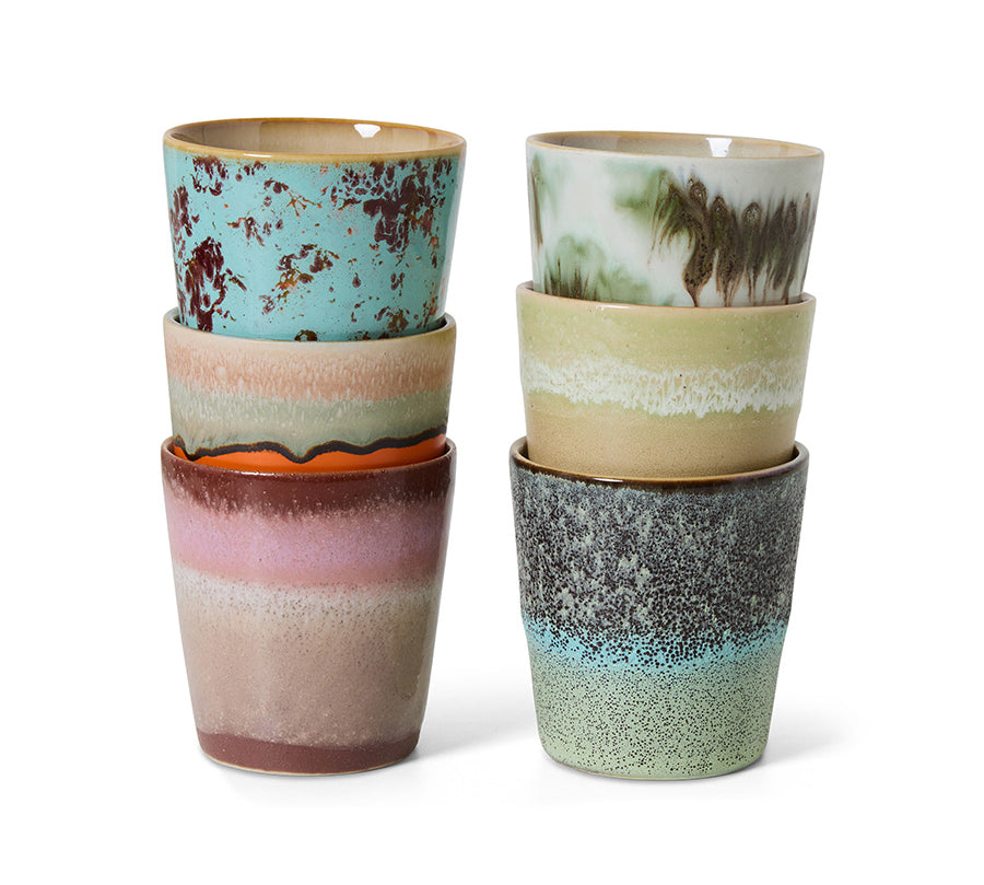 Set of six ceramic cups with multicolored glaze patterns on a white background