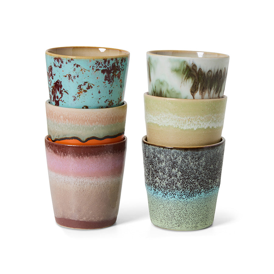 Set of six ceramic cups with multicolored glaze patterns on a white background