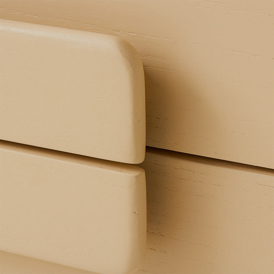 Close-up of beige wooden drawers with a soft focus background