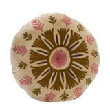 A round decorative Suzani throw pillow with a hand-embroidered geometric and floral pattern in olive green, dusty pink, and dark brown on a cream-colored velvet fabric, shown against a plain white background.
