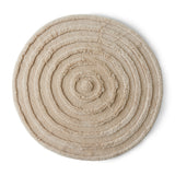 A round wool rug in cream color with a textured pattern.