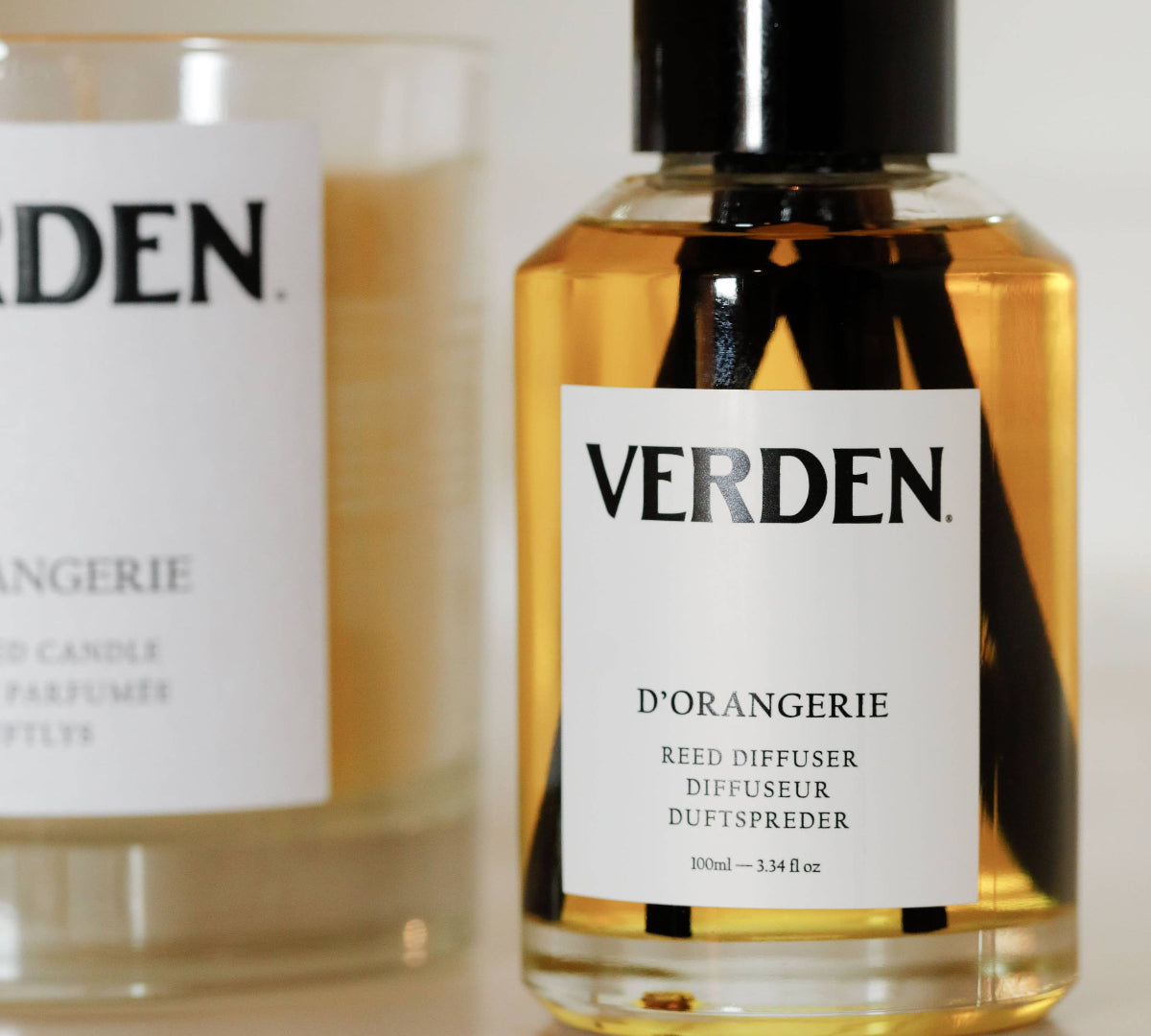 Verden diffuser and candle on a white surface
