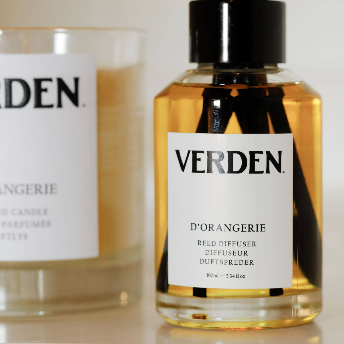 Verden diffuser and candle on a white surface