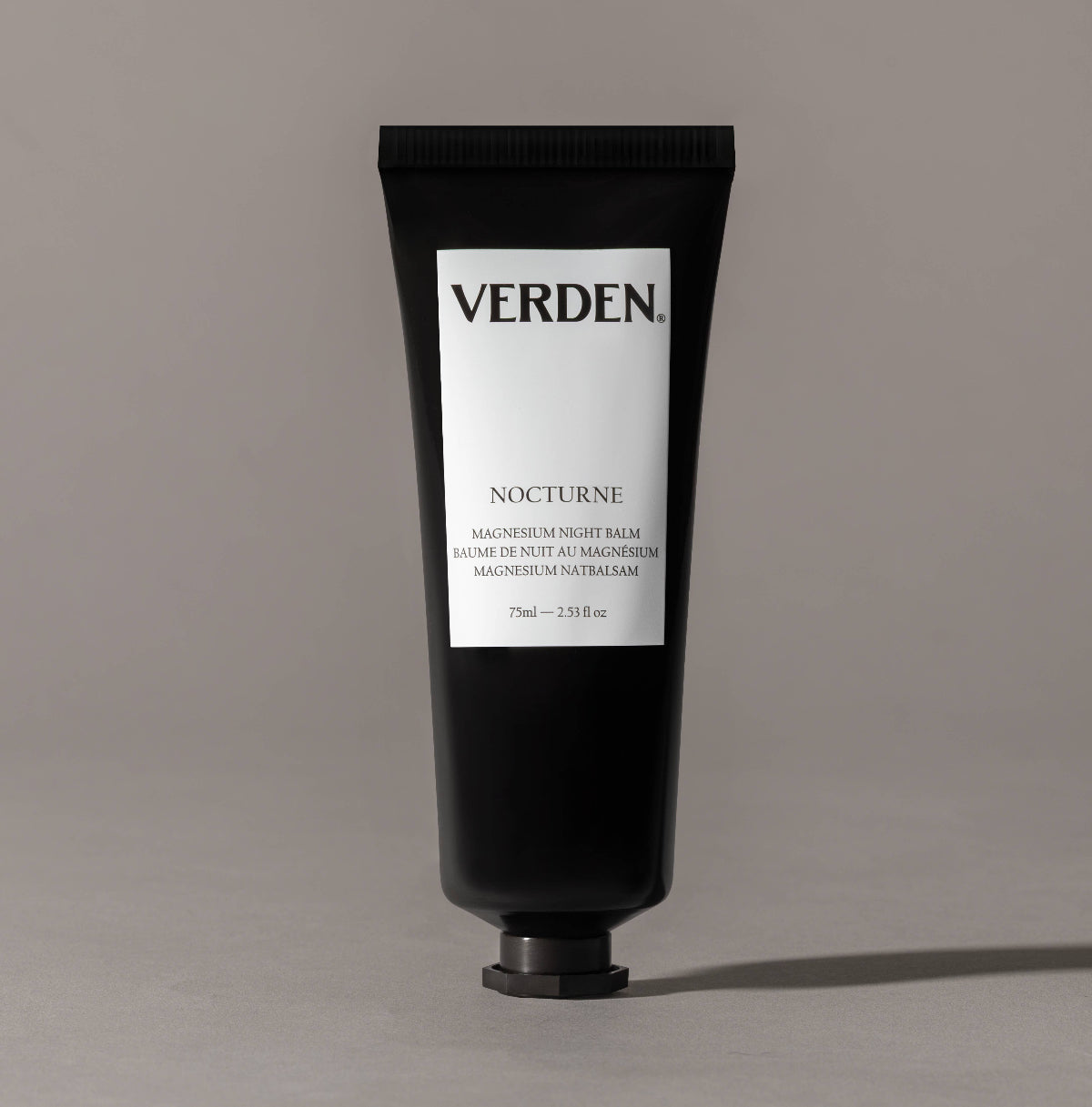 Black tube of Verden Nocturne balm on a gray background