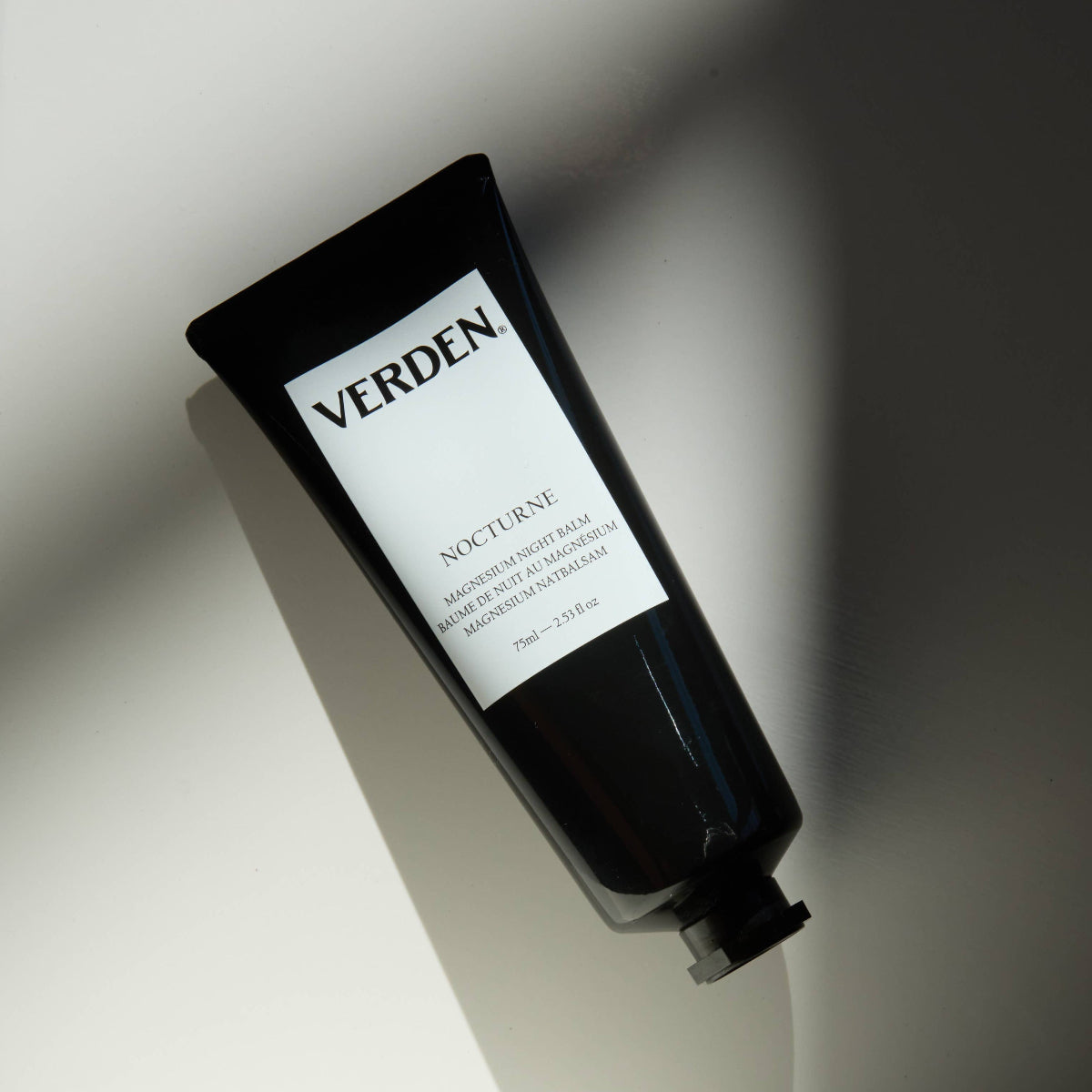 Black tube of Verden Nocturne magnesium skincare product on a light background