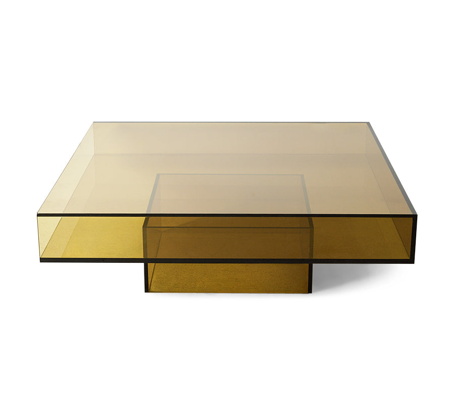 A modern square coffee table with a translucent amber-tinted glass top and matching glass base, shown on a clean white background.