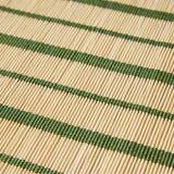 Close-up of a woven placemat with green and beige stripes