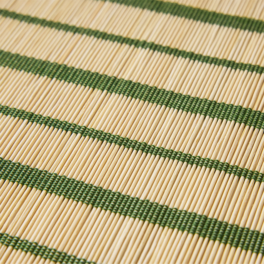 Close-up of a woven placemat with green and beige stripes
