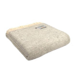 Textured beige wool blanket with a brand label on a white background