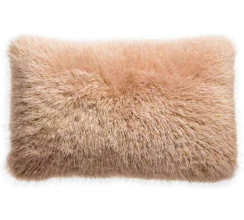 A rectangular fluffy faux fur pillow in a soft dusty beige color, shown against a plain white background.