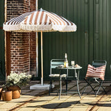 bistro table and chairs and striped umbrella