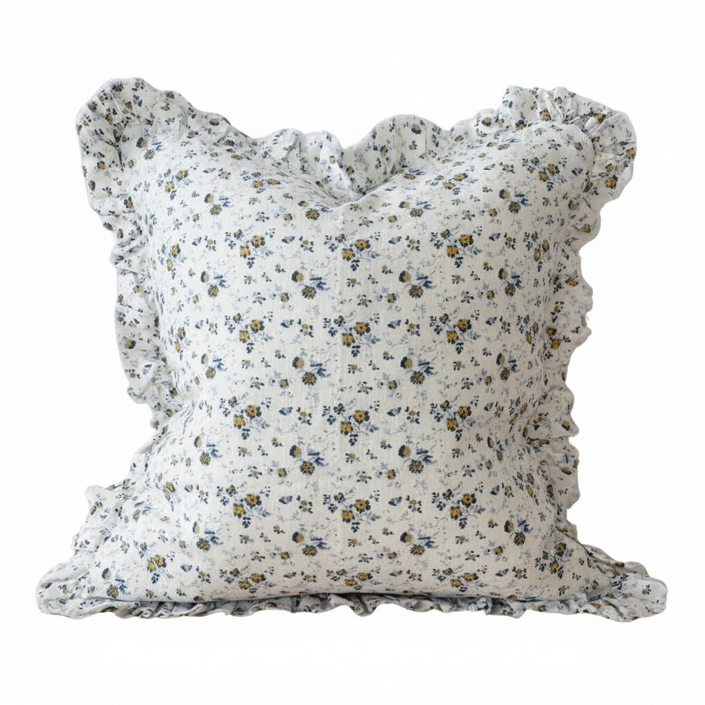 Floral patterned pillow with ruffled edges on a white background