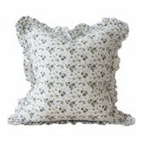 Floral patterned pillow with ruffled edges on a white background