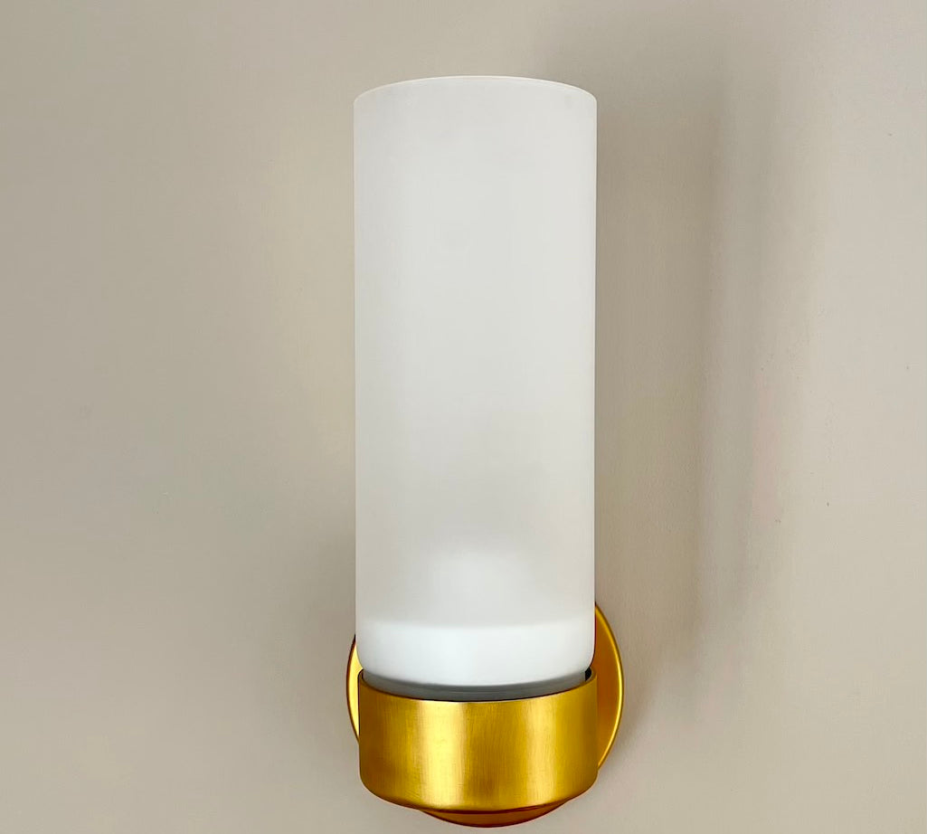brass wall light with white glass shade