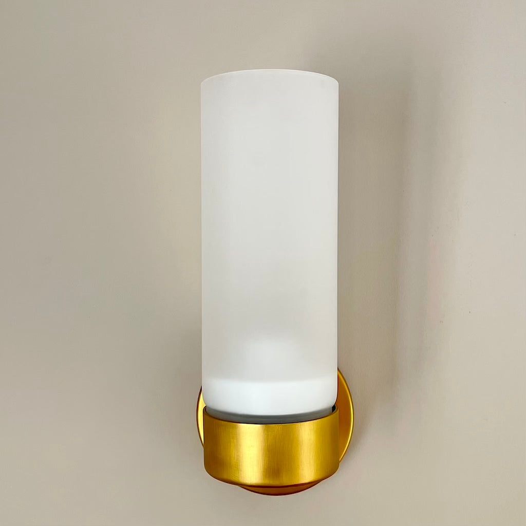 brass wall light with white glass shade