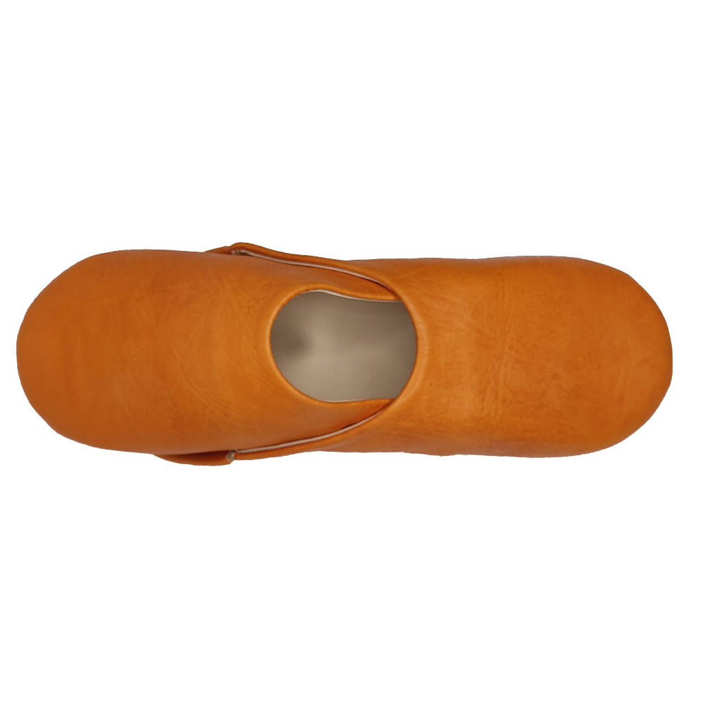 A top-down view of a single orange leather bootie or clog with a strap closure, shown on a plain white background.