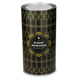 A cylindrical metal tin for a 'Luxury Manhattan Cocktail Set' featuring a black and gold Art Deco pattern, shown on a plain white background.