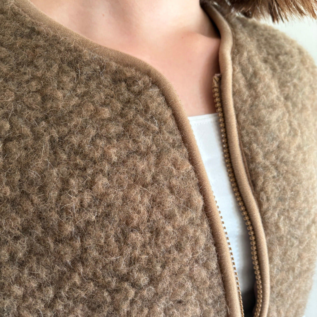 Close-up of a brown Coldbreaker vest by Yoko wool