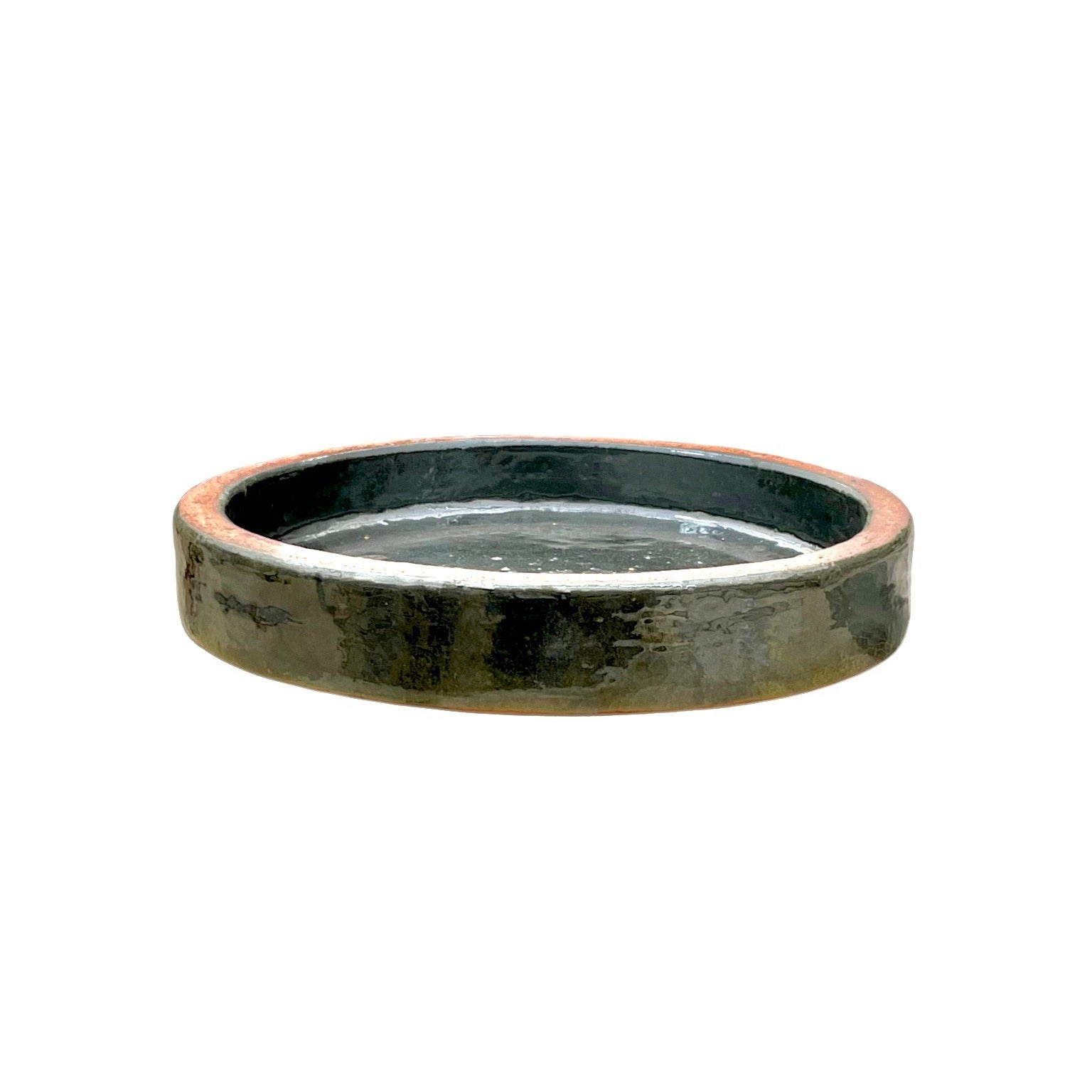 Round green stone bird bath on a white background
