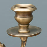 Brass candle holder on a gray background