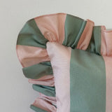 Close-up of a pink and green striped fabric with a plain background
