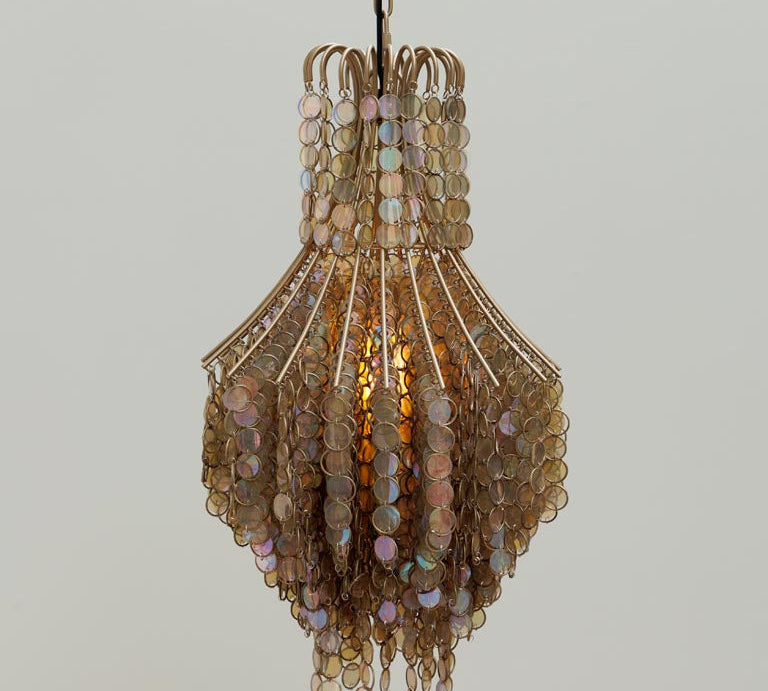 Decorative pendant light with beaded design on a plain background