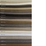Stack of fabric swatches in various colors with labels on a white background