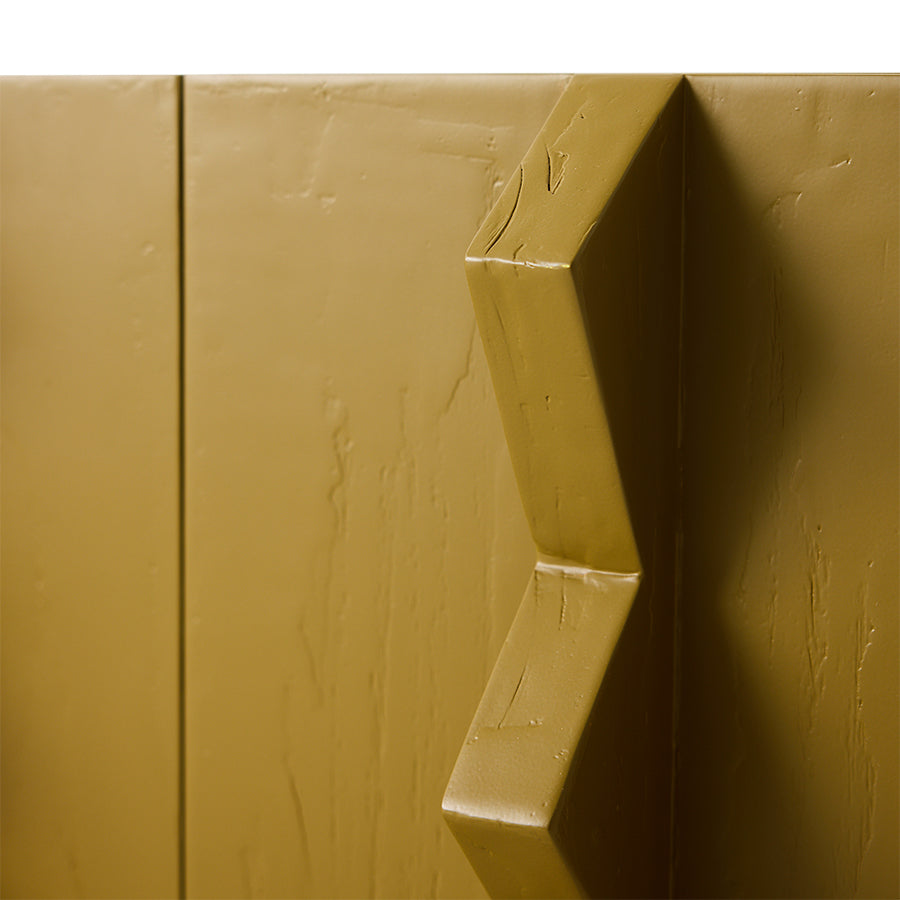 Close-up of an olive green door handle on a wooden door