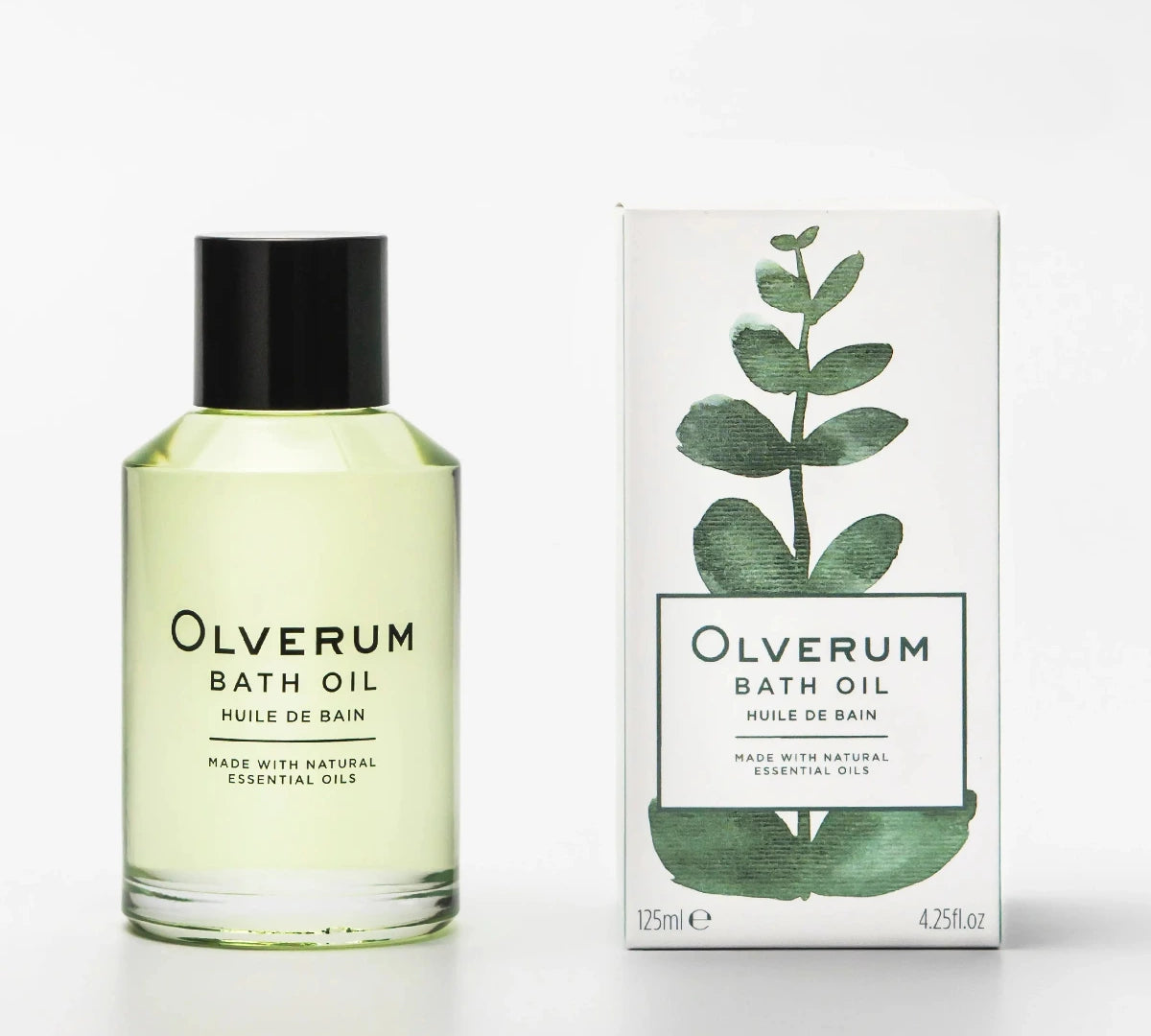 Olverum Bath Oil bottle with a black cap next to its white packaging box featuring a green eucalyptus leaf illustration, on a clean white background.