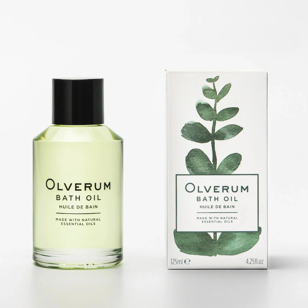 Olverum Bath Oil bottle with a black cap next to its white packaging box featuring a green eucalyptus leaf illustration, on a clean white background.