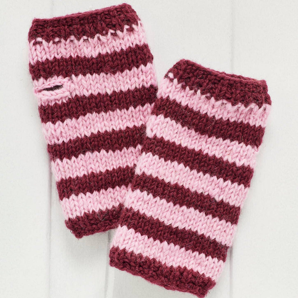 A pair of hand-knit hand warmers featuring horizontal stripes of deep burgundy and light pink, displayed on a white wooden background.