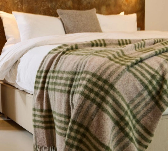 olive green and beige check wool throw on bed
