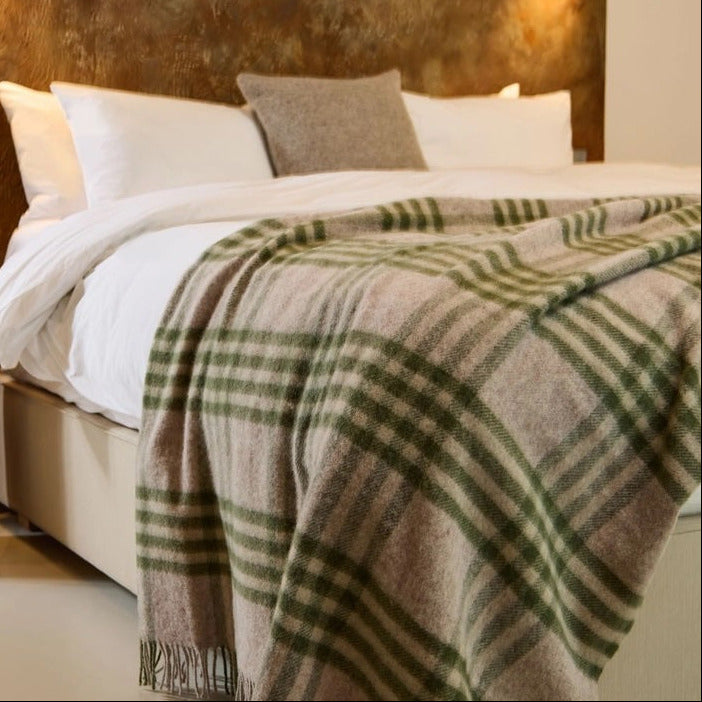 olive green and beige check wool throw on bed