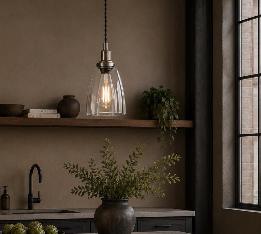 Modern kitchen with pendant light, plants, and window view.
